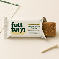 Full Turn Vanilla Honey Crunch protein bar with packaging on a light surface